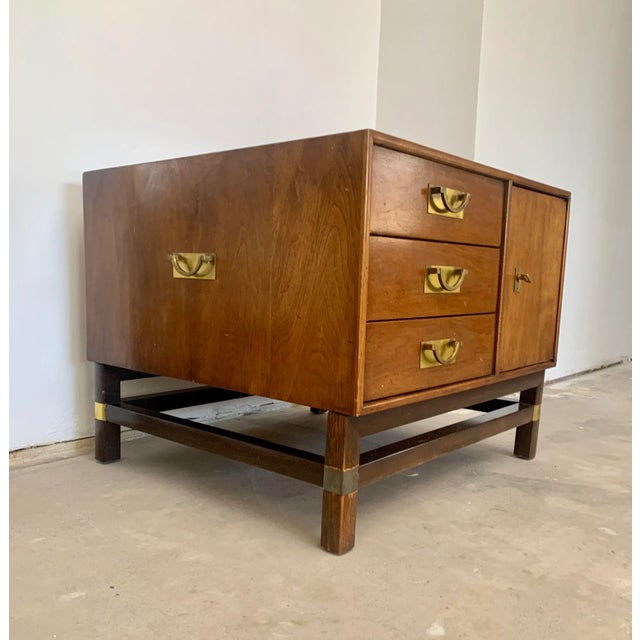 Side table with 3 drawers and ample storage space behind the door. The brass enforced frame carries the high placed, chest...