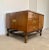 Side table with 3 drawers and ample storage space behind the one door. The brass enforced frame carries the high placed,...