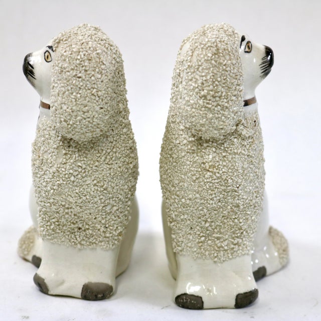 This lovely pair of vintage white Staffordshire Ware poodle figurines, one facing left and the other right, was crafted in...