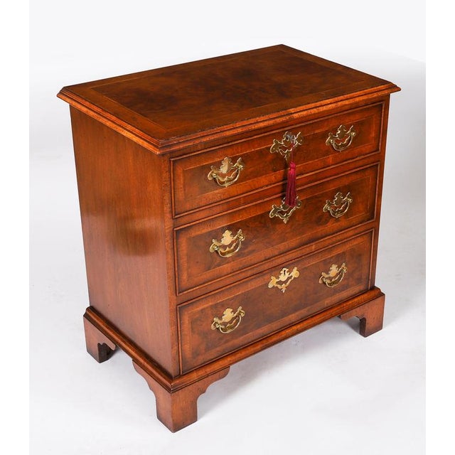 This is a beautiful vintage pair of Georgian Revival burr walnut chests, dating from the mid 20th Century. The chests are...