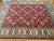 This is a Caucasian Kazak Lori Pambak-style rug, easily recognized by its rich red field, scattered tribal medallions, and...
