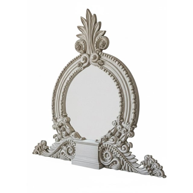 The manufacturer and specific iron species for this mirror are unknown.This monumental Neoclassical-style wall mirror is...