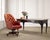 A handsome English Georgian style executive swivel desk chair, upholstered in a rich tufted leather. The chair features a...