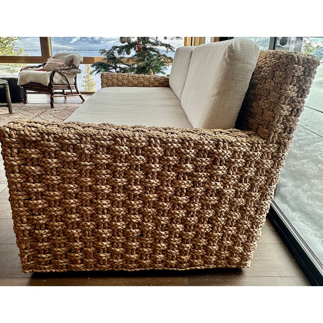 Beautifully woven sofa in natural color with bench cushions in off-white, performance canvas. Excellent condition. Serena...