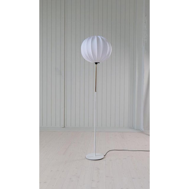 This floor lamp made by Bergboms Sweden in the 1960s. The white metal base works good with the brass part of the lamp....