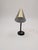 Mid-century Danish desk lamp with a brass gooseneck. Also featuring holes one the bottom of the lamp for wall mounting.