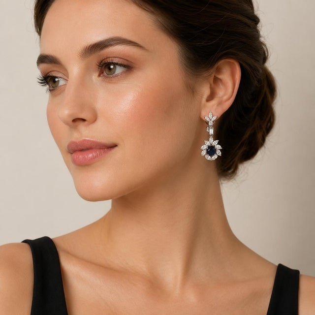 Platinum & 18k White gold hand fabricated earrings containing 2 AGL cerified no heat sapphires weighing 4.84 carats and 24...