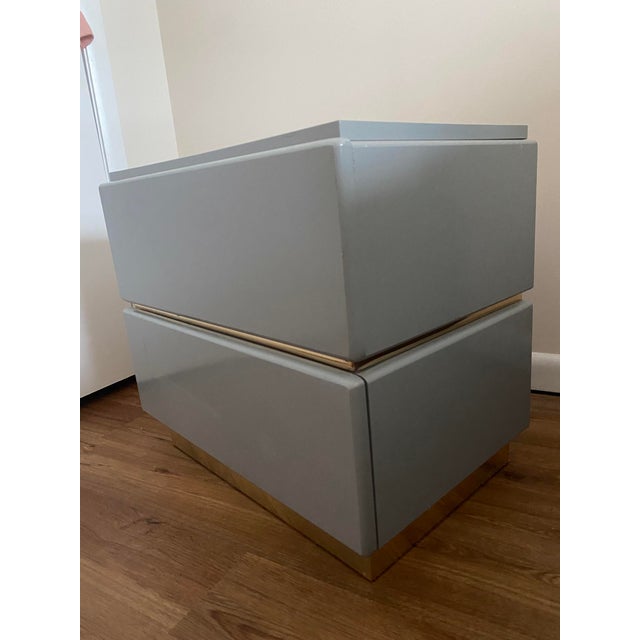 Single postmodern blue-grey lacquer & brass nightstand by Lane, circa 1980s. With its sleek, geometric silhouette and high...