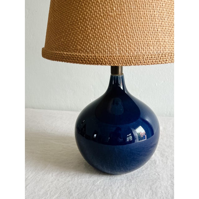 This delightful Mid-Century Modernist Cobalt Blue Glazed Ceramic Table Lamp by Lotte and Gunnar Bostlund originates from...