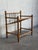 Turned wooden posts support open framing and metal spindle slatted shelves for compact storage. This versatile piece...