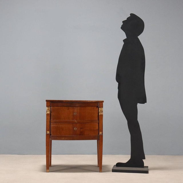 Empire walnut bedside table. Door composed of two false drawers, concealing an internal six-drawer cabinet with cutlery...