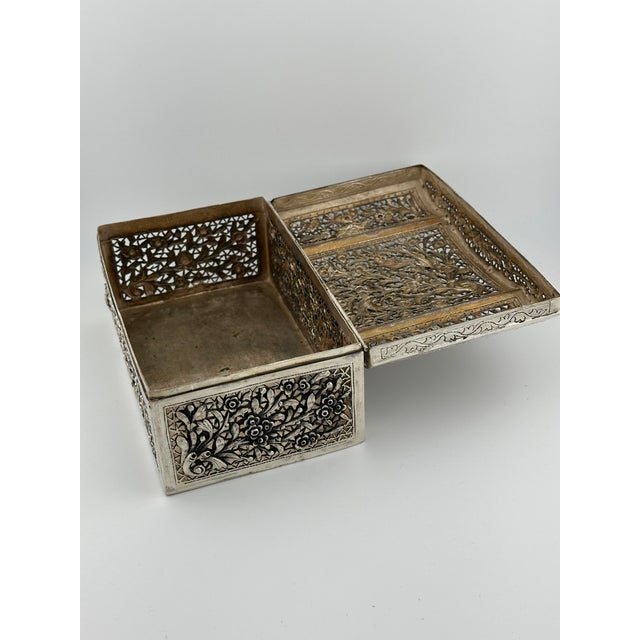This antique silver lidded box features exquisite craftsmanship with pierced, hammered, and repoussé detailing. The dome-...
