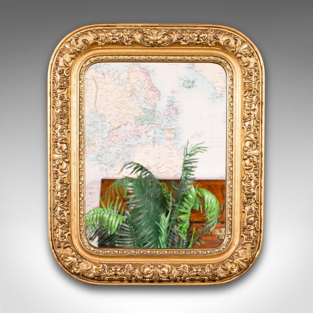 This is a small antique hall mirror. An English, gilt gesso vanity wall mirror, dating to the Georgian period, circa 1800....