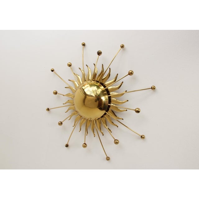 An extremely rare brass wall light, made in Germany in the 1950s. The light features a pull switch and two E14 (E12)...