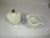 Raymond Waites white porcelain sugar and creamer from his Empire collection. They are footed and decorated with raised...