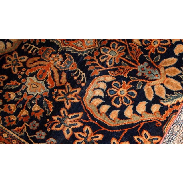 Antique hand-woven Sarouk rug in navy blue colour. The rug is in original good condition, made in the beginning of 20th...