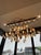 Stunning custom chandelier featuring suspended hand-formed glass crystal elements in clear and amber tones. Each piece is...
