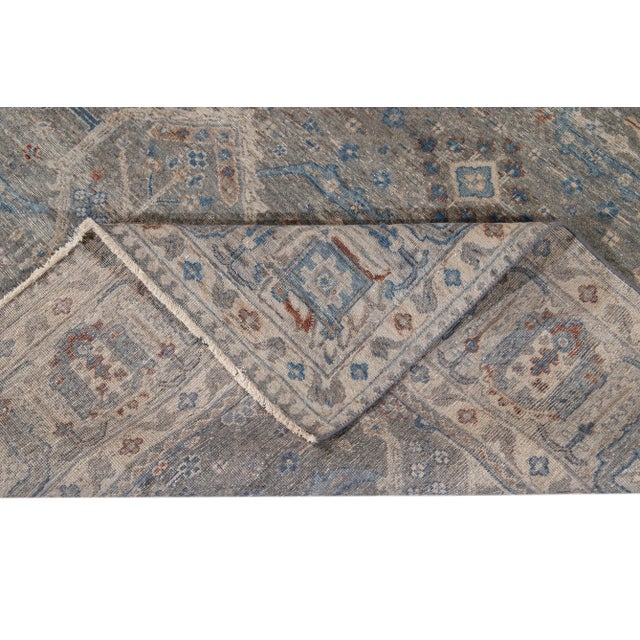 Beautiful modern hand-knotted Indian wool rug with a gray field, blue, brown, and ivory accents with an all-over geometric...