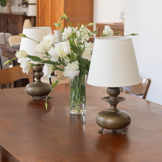 Stunning pair of antique metal table lamps from France, 1940s. Brass sculptural metal body with three claw feet detail....