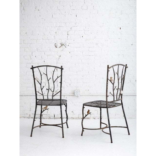 Dining set with 4 chairs and table. The table and chairs are crafted with hollow metal tubing, scuplted to resemble tree...