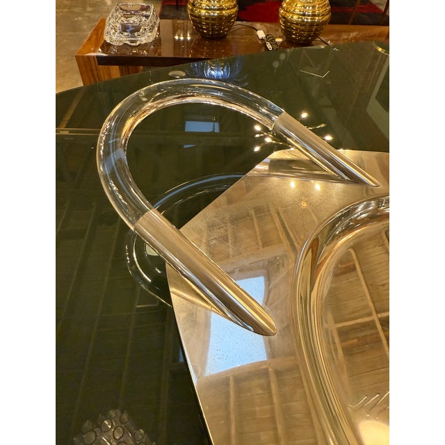 Elegant Italian modern serving or display tray from the 1970s, featuring an oval Lucite body paired with sculptural...