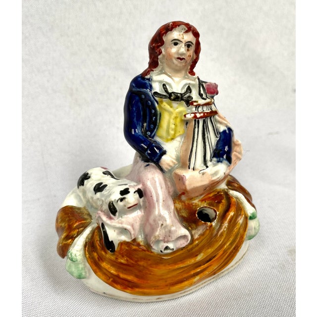Antique Staffordshire hand painted man with dog inkwell/pen holder figurine. Brilliant colors adorn this classic English...