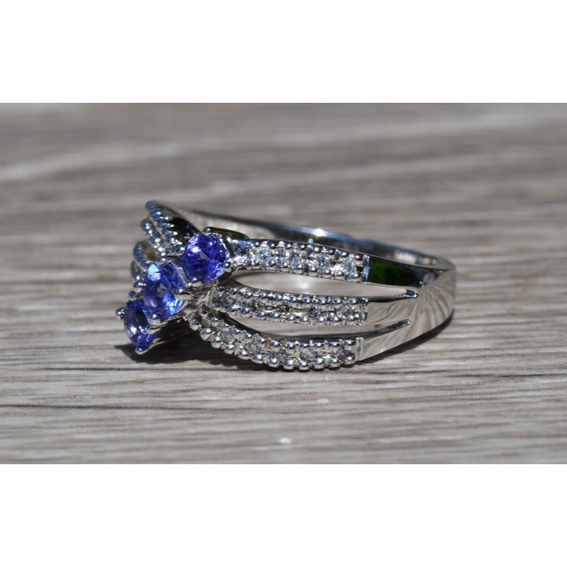 The Alatus Ladies 14K Gold Ring set with 0.51 CTW Tanzanite and 0.14 CTW Diamonds. Crafted in desirable 14 karat white...