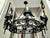 Large Spanish Revival (or Gothic style) black metal forged 8 light chandelier. This fixture is perfect for your entryway,...