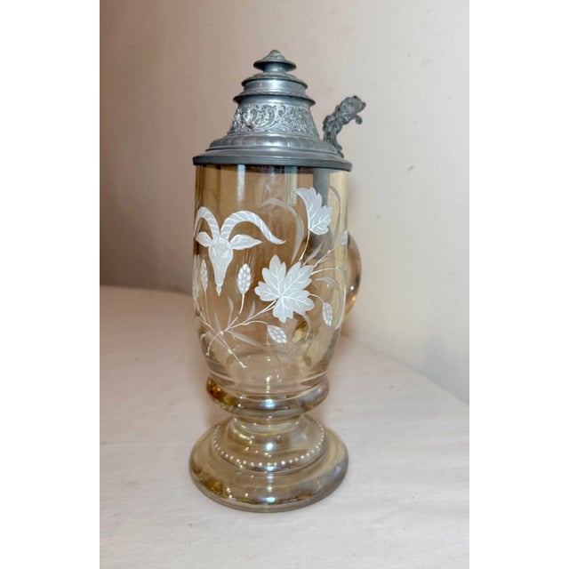 Up for sale is a lovely antique lidded yellow glass and pewter German beer stein. It's blown with a lovely applied handle...