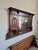This piece is a large, wall-mounted antique which likely originated as a mantle or sideboard top/buffet mirror crafted...