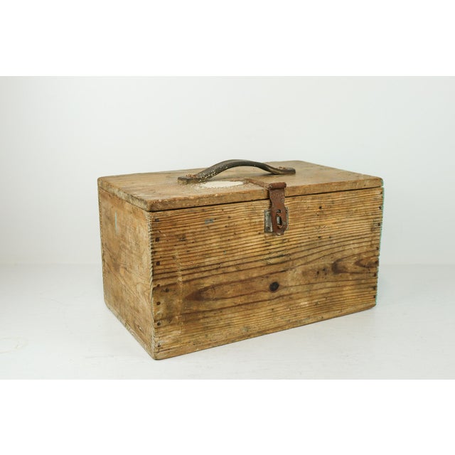 This old handmade wooden toolbox is a beautifully weathered example of traditional craftsmanship, featuring an...