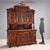Neo-Renaissance-style sideboard in richly carved walnut. The upper part features a pair of central stained-glass doors and...