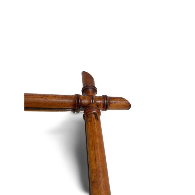 Rectangular mirror with a turned wood frame simulating bamboo stalks, forming a decorative motif characteristic of the...