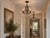 There is a particular pleasure in finding two of anything — and these chandeliers are a rare matched pair, ready to anchor...