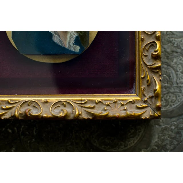 A highly detailed miniature portrait of a young man in a shadowbox. The portrait is set under glass, inside a gold-toned...