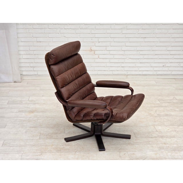 1970s, Danish swivel armchair by Georg Thams. Original brown furniture leather, bent beech wood, nubuck leather. Original...
