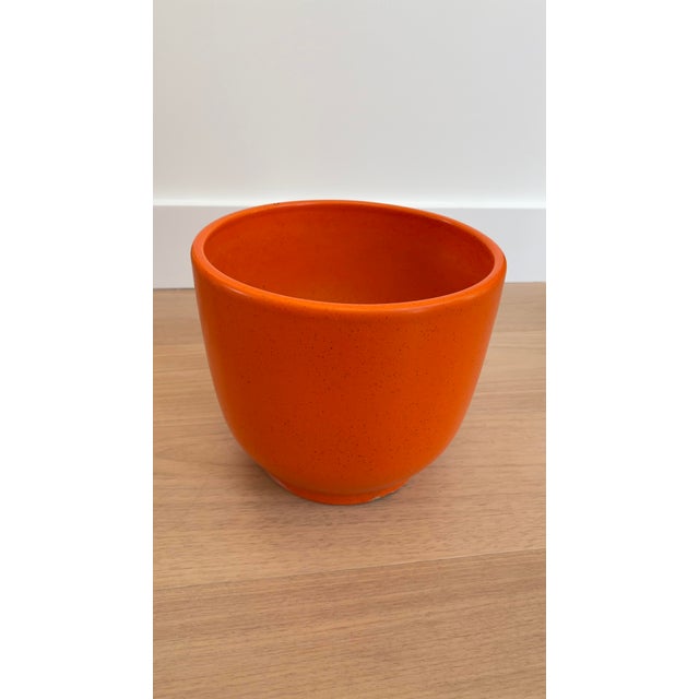 Add a pop of color and iconic design to your indoor or outdoor decor with this vibrant orange Gainey Pottery planter. The...