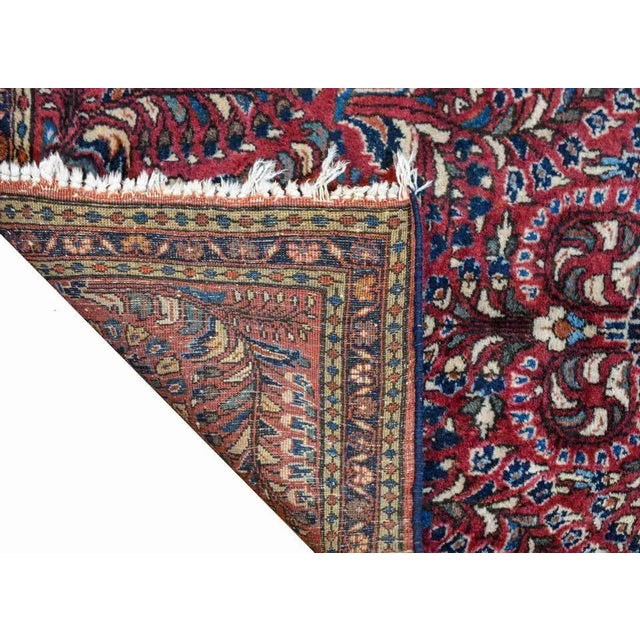 A beautiful early 20th century Persian Sarouk rug with a traditional mirrored tree-of-life pattern including myriad...