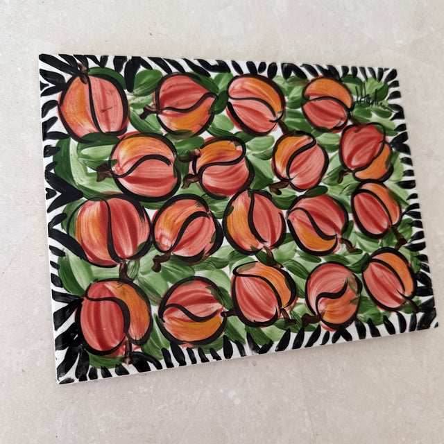 Charming hand-painted peach clay trivet. Signed by maker. Bottom is lined in cork. Most items found at Pub & Oasis are...
