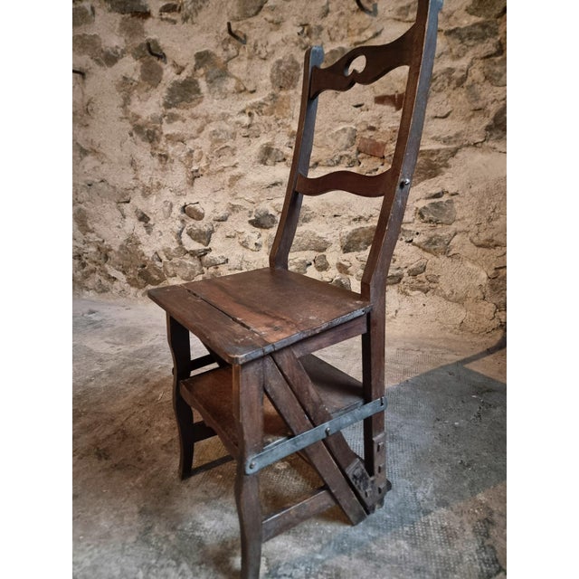 French metamorphic library chair crafted from solid beechwood and dating from the early 20th century. Designed as a...