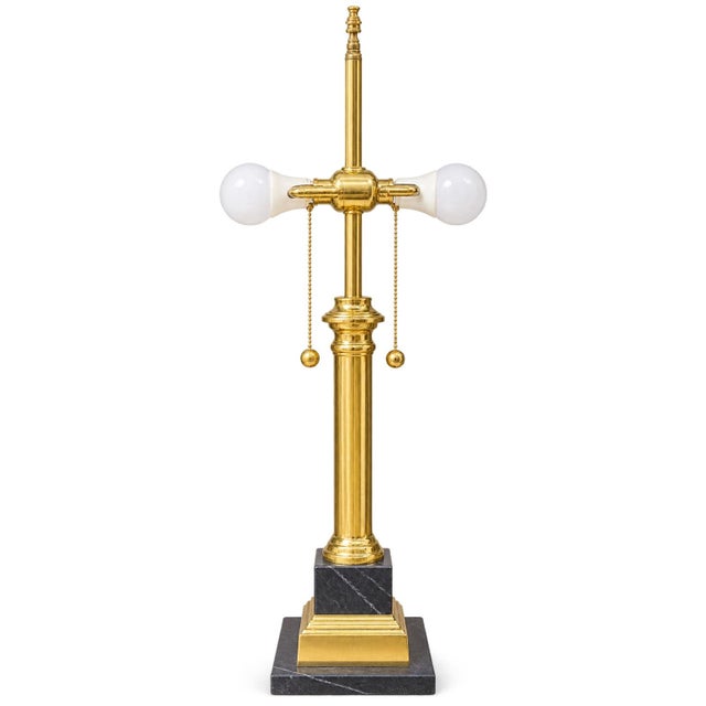 Striking vintage table lamp featuring a tall, slender Empire-style brass column mounted on a substantial Italian black...