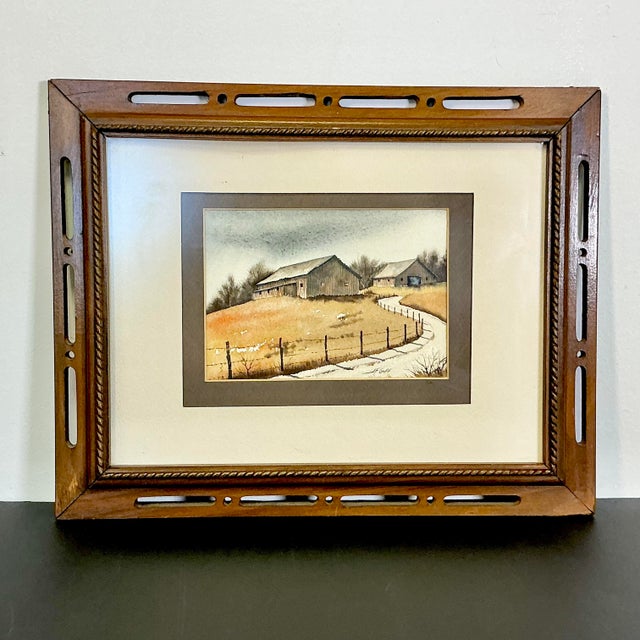 Artist JF Goff has created this little watercolor painting featuring a rural landscape with two weathered barns up a lane...