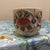 This stunning antique porcelain cup features a highly textured, hand-decorated design. It showcases vibrant pink central...