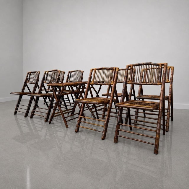 Stunning set of eight 1980’s rustic tortoiseshell bamboo folding chairs with two matching side tables. These chairs give a...