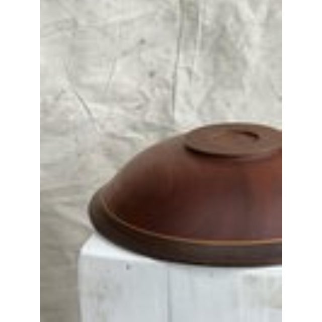 this stunning vintage solid wood bowl is assembled coated in a dark brown and mahogany finish adorned with a golden...
