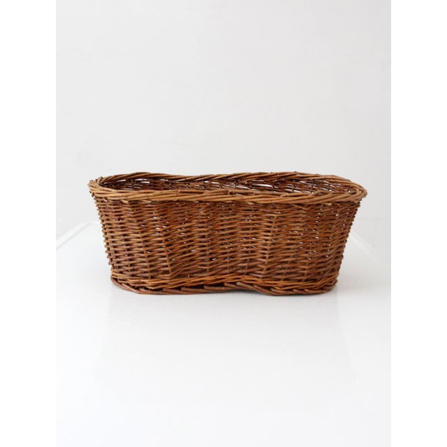 This vintage wicker basket features a warm, timeworn look with a softly shaped silhouette and rich woven texture...
