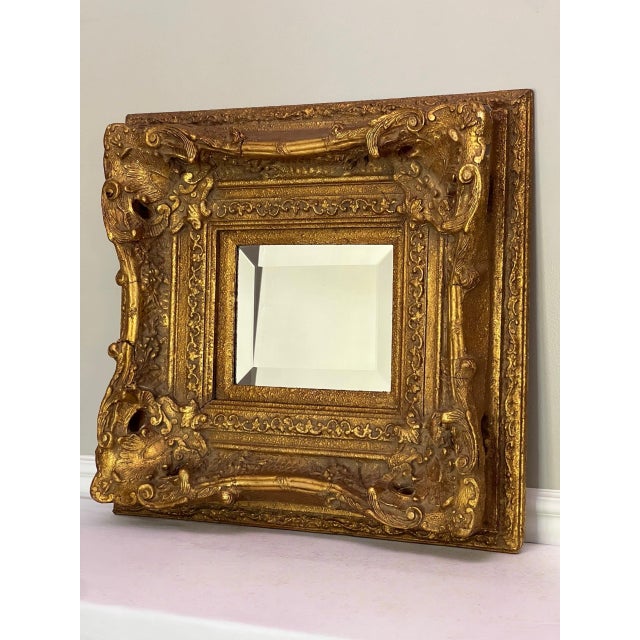 Magnificent antique Baroque Revival beveled mirror with a wide and deep, profusely carved giltwood frame, circa 1860s. The...