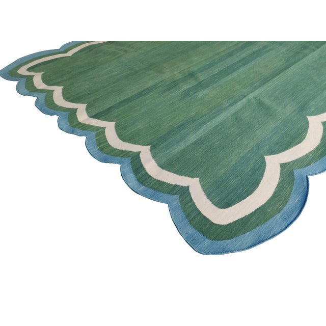 Cotton Scalloped Edge Reversible Rug. Scalloping borders entire rug. These special flat-weave dhurries are hand-woven with...