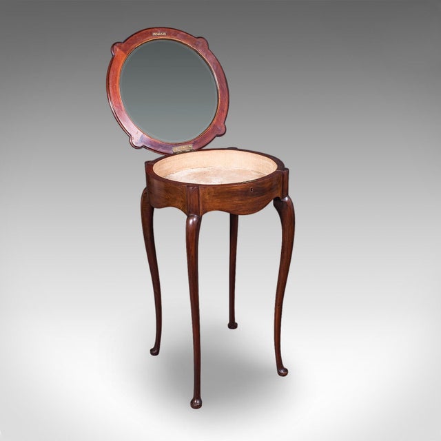 This is a small antique bijouterie table. An English, mahogany and glass display case, dating to the Edwardian period,...