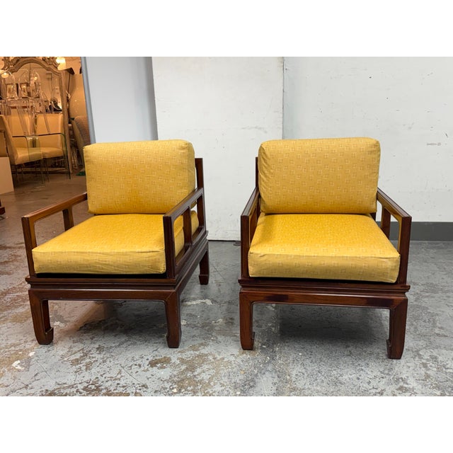 Design Plus Gallery presents a Pair of Vintage Asian Rosewood + Cushion Arm Lounge Chairs. The chairs are a low, grounded...